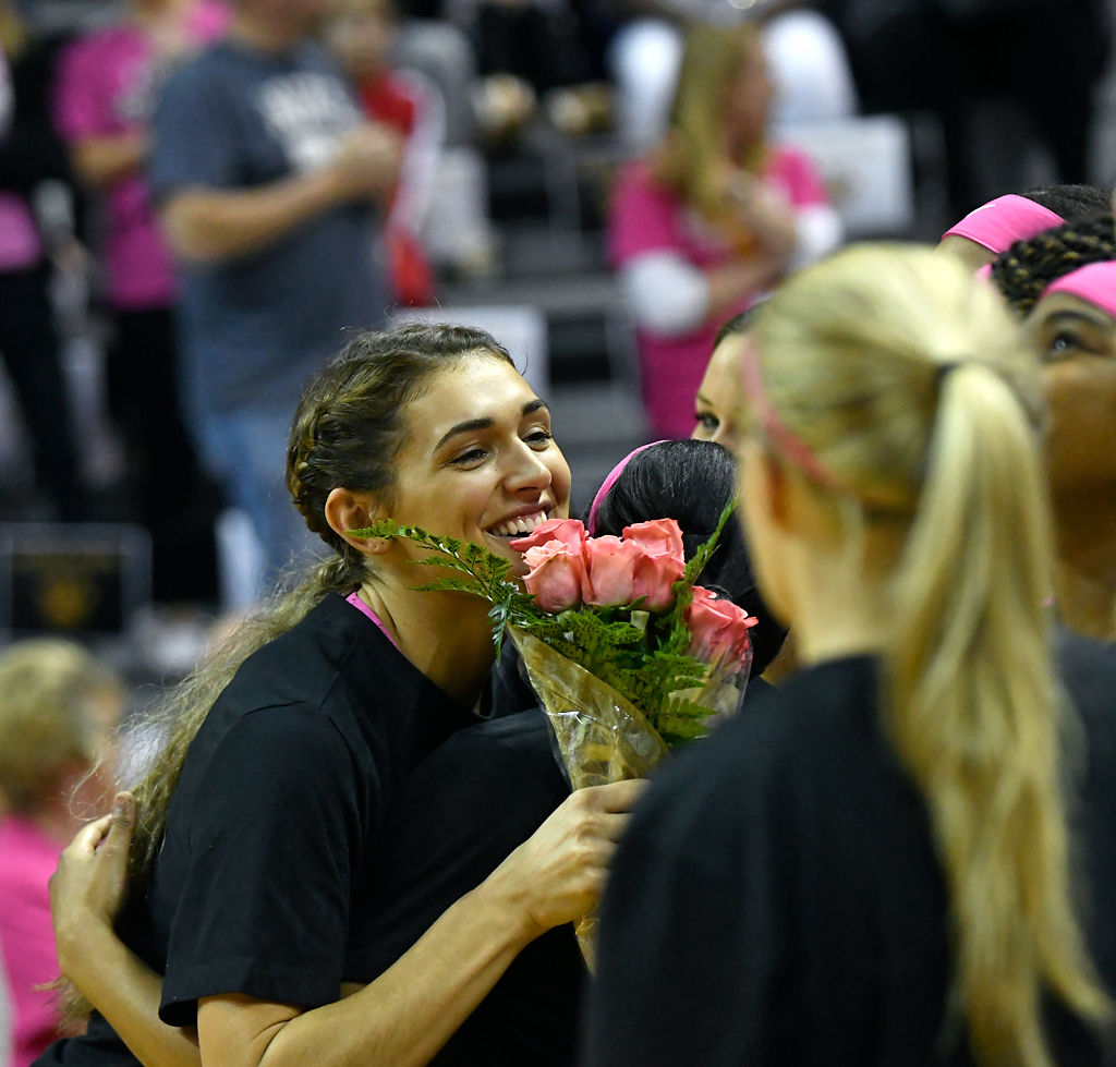 Hannah Schuchts hugs her teammates during her senior night